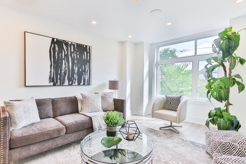 Contemporary open-plan living room with sleek furniture and accent art